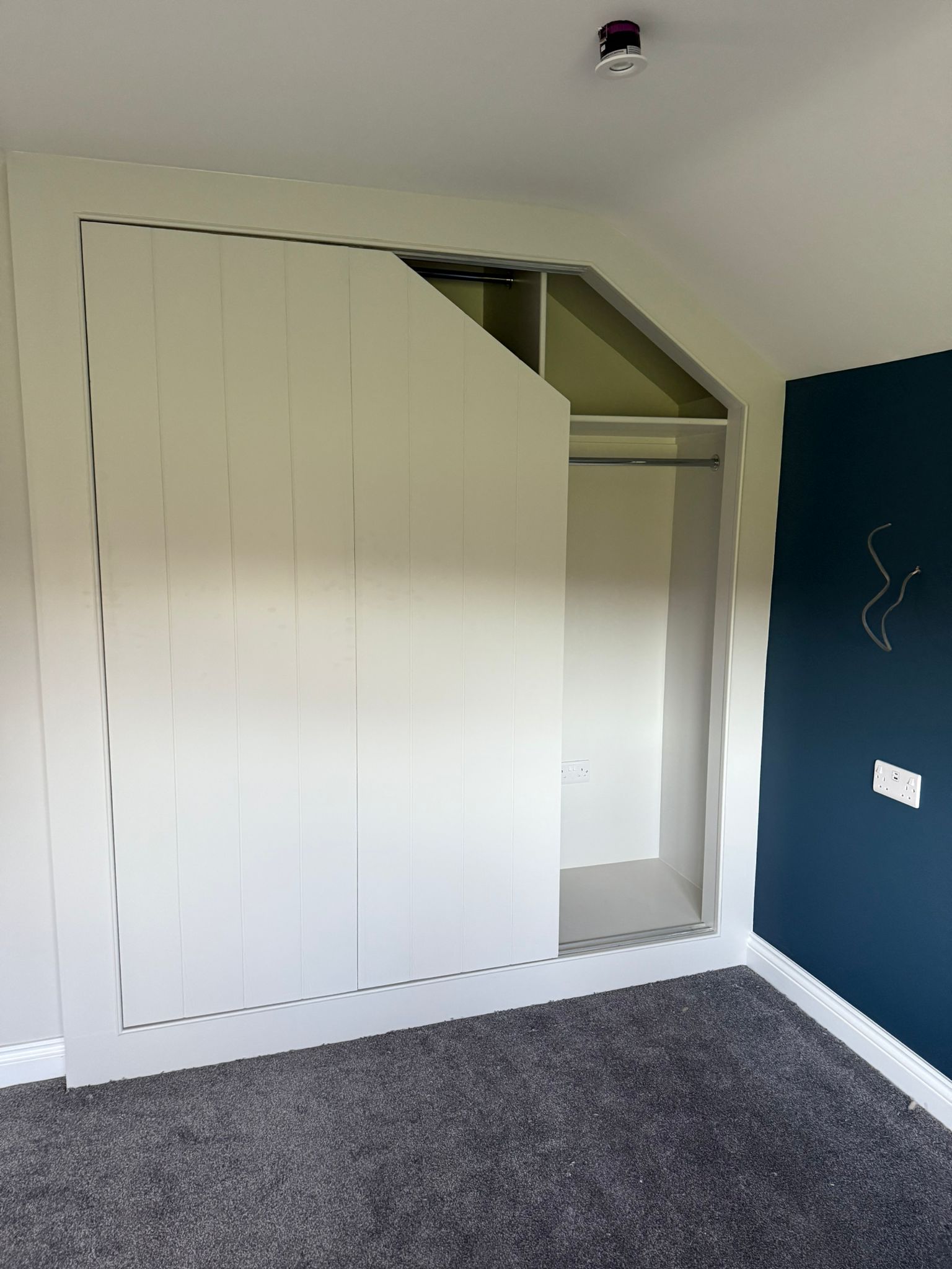 loft-wardrobe-half-open-navy-wall